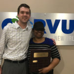 Corvus employee and Corvus Franchisee holding an award