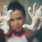 Little girl with soapy hands - wash hands often to avoid coronavirus