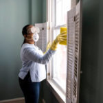 woman cleaning and disinfecting home