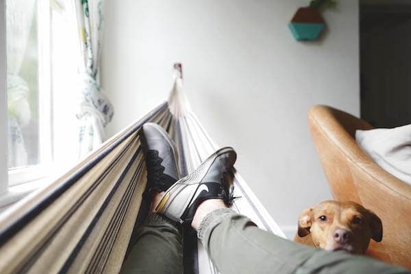 Manage stress at home: man in hammock