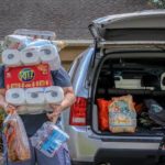 Man carrying groceries into home