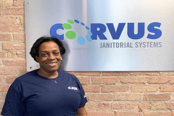 Corvus franchise owner Marcia Byrd in front of Corvus sign