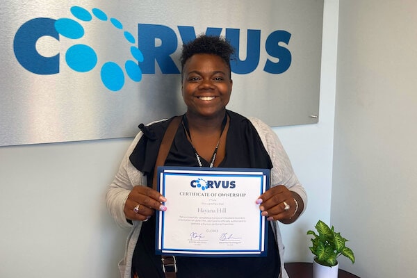 Franchise Owner Hayana Hill with welcome certificate