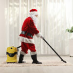 Professional cleaner dressed as Santa cleaning the floor