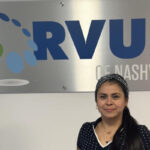 Corvus of Nashville Franchise Owner Laurybel Figueroa Villarreal in front of Corvus sign
