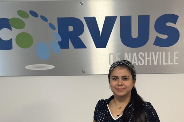 Corvus of Nashville Franchise Owner Laurybel Figueroa Villarreal in front of Corvus sign