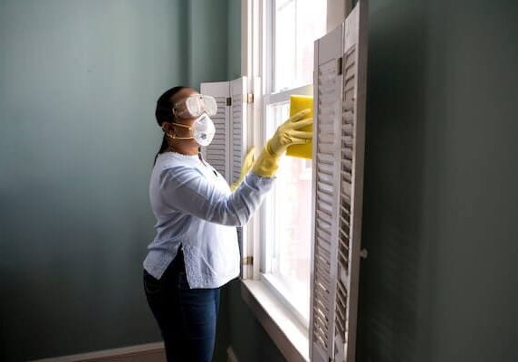 woman cleaning and disinfecting home