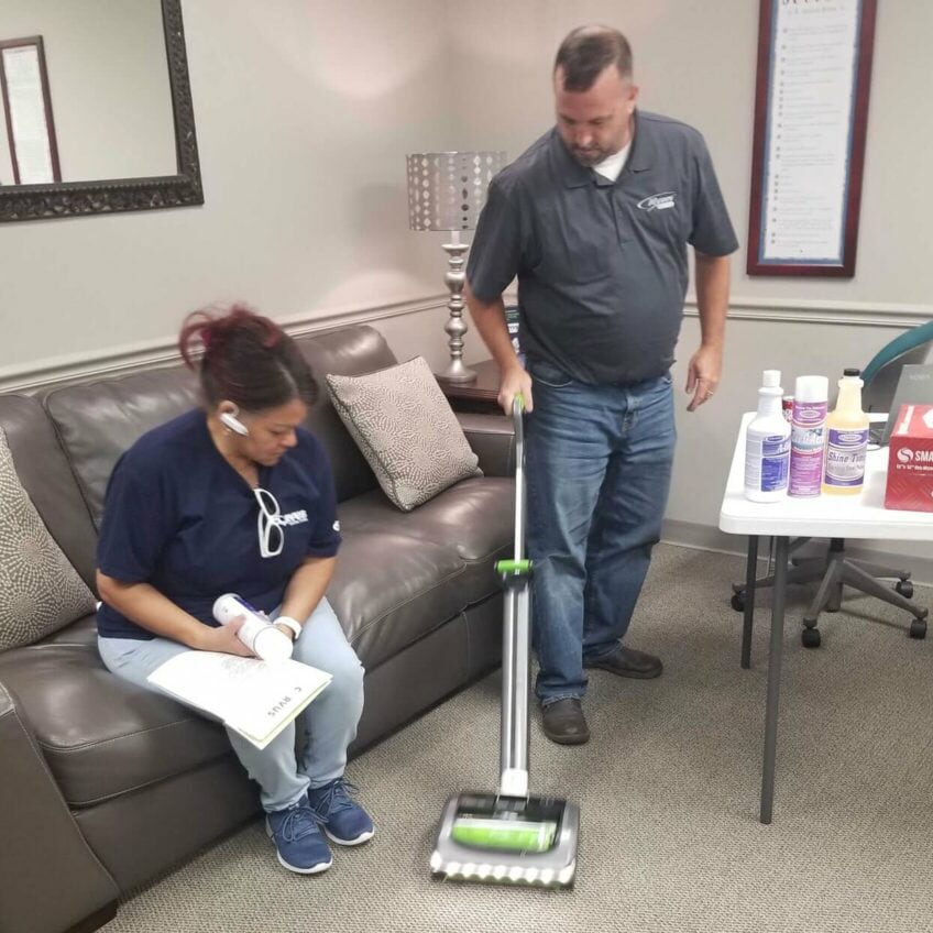 Corvus Franchisee learning carpet cleaning techniques from a Corvus employee